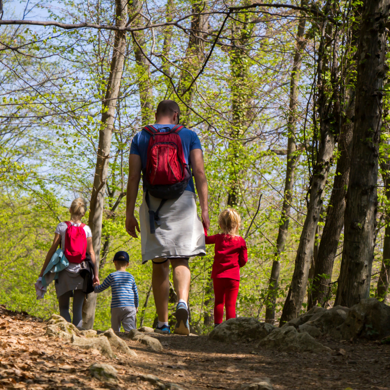 Family trekking together on a scenic trail in Nepal Himalayas